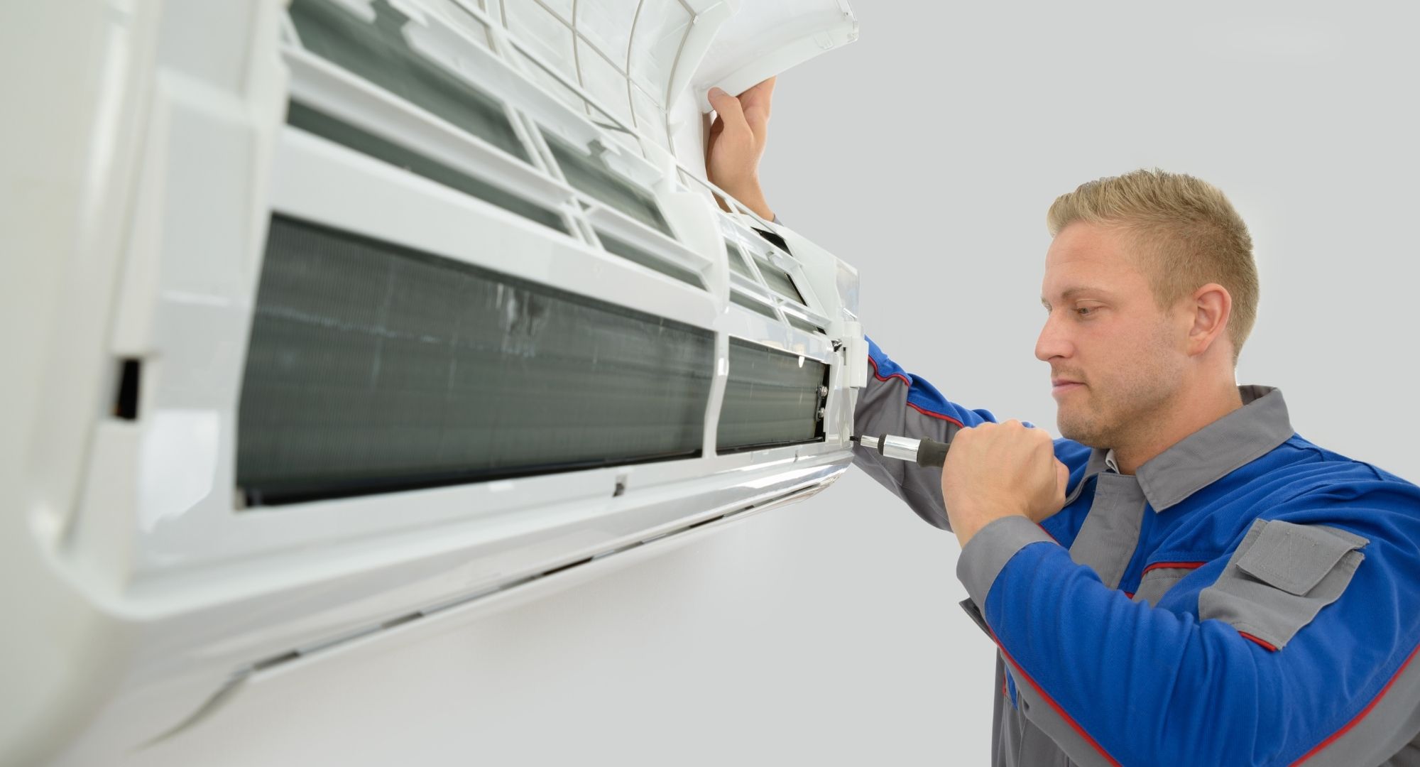 technician giving a thumbs-up next to a newly installed high-efficiency HVAC system