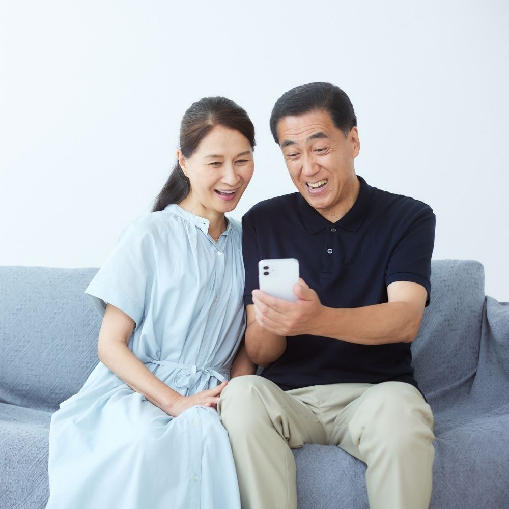 homeowners looking at bill on phone and happy