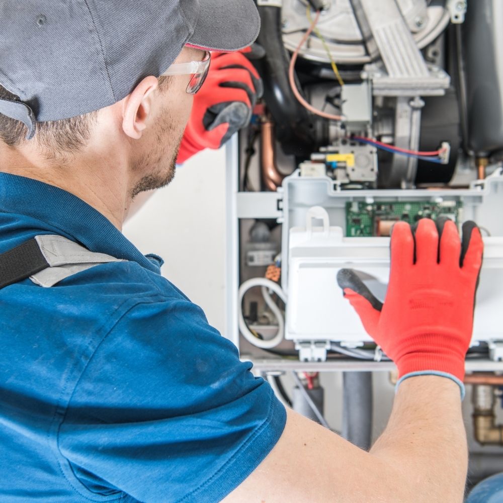 HVAC contractor working on furnace repairs