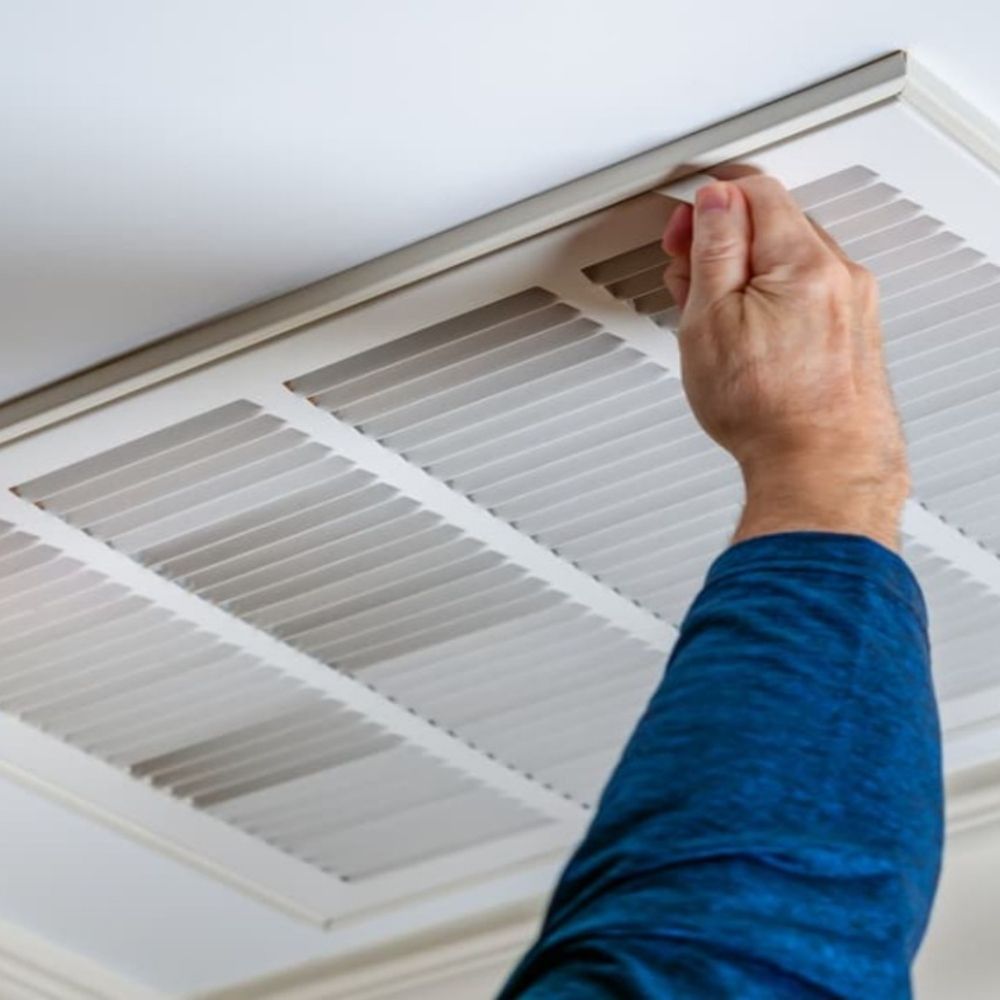 person opening vents in a home