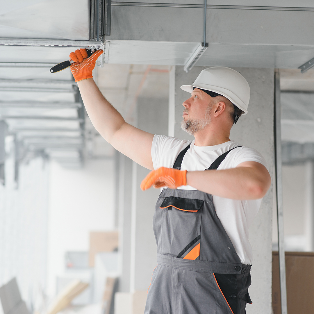 hvac technician doing maintenance on unit