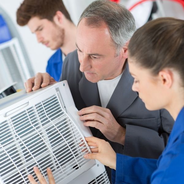 HVAC techs working on AC.